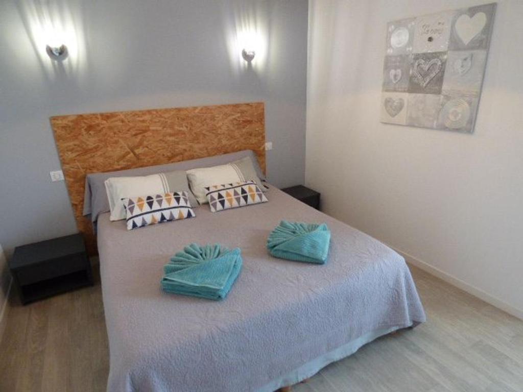 a bedroom with a bed with two pillows on it at Gîte Le Bernard, 6 pièces, 10 personnes - FR-1-426-164 in Le Bernard