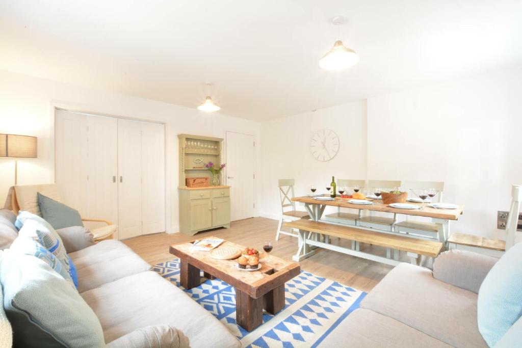 a living room with a couch and a table at Corner Cottage, Thorpeness in Thorpeness