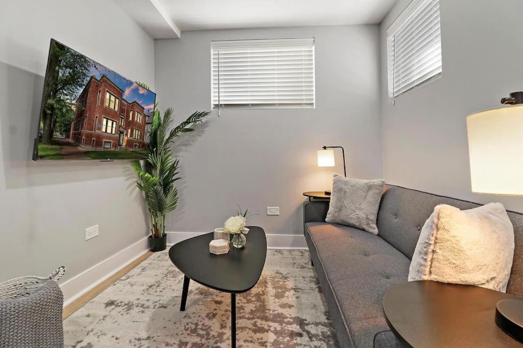 a living room with a couch and a table at 2BR Apartment close to Local Cafes & Stores - Magnolia G in Chicago