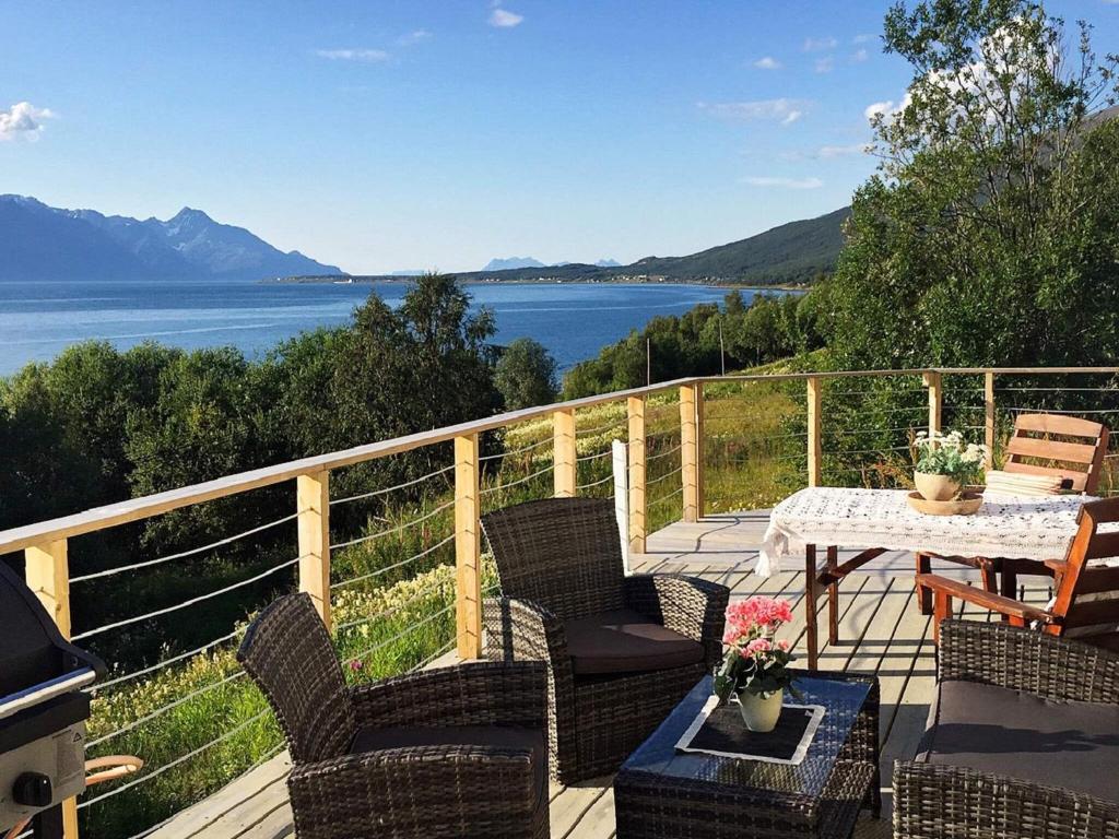 a patio with a table and chairs and a view of the water at 6 person holiday home in Olderdalen in Olderdalen