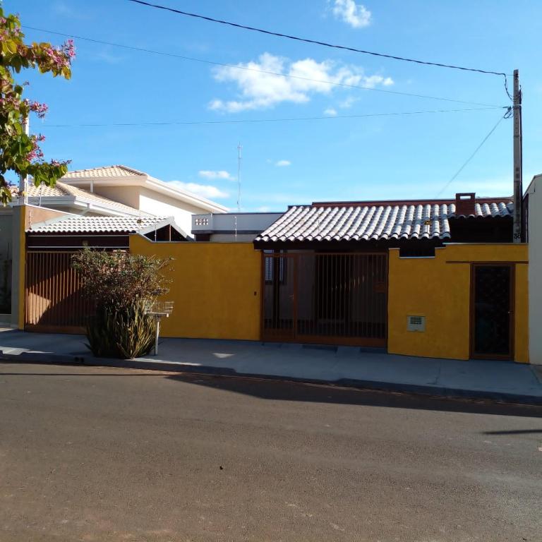 a row of yellow buildings on a street at Villa Maria DA Luz ROCHA Olimpia in Olímpia
