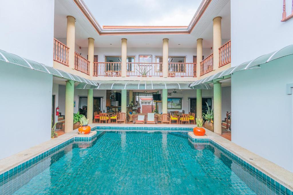 an indoor swimming pool with a large house at Evergreen boutique Hua Hin in Hua Hin