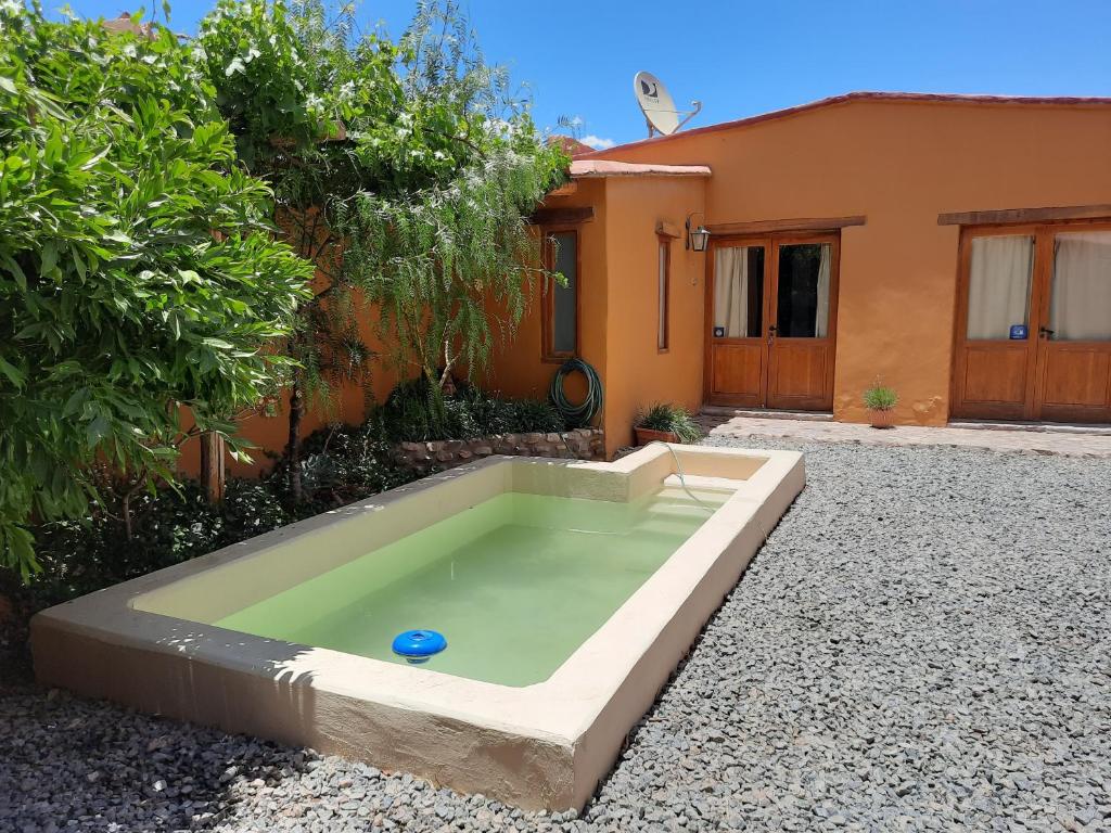 a swimming pool in a yard next to a house at Cabañas Tilcara Mia in Tilcara