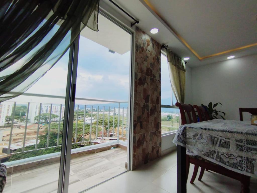 a bedroom with a large window with a view of the ocean at Hermoso Apartamento Estancia Tranquila por dias, semanas o meses in Jamundí