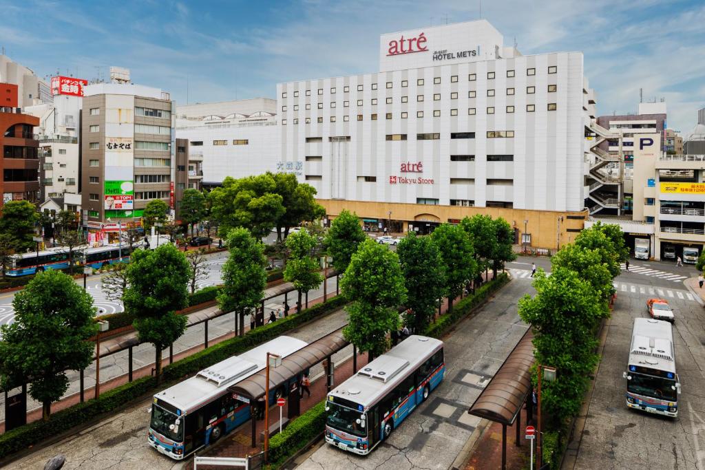 a group of buses parked in a city at JR-East Hotel Mets Omori in Tokyo