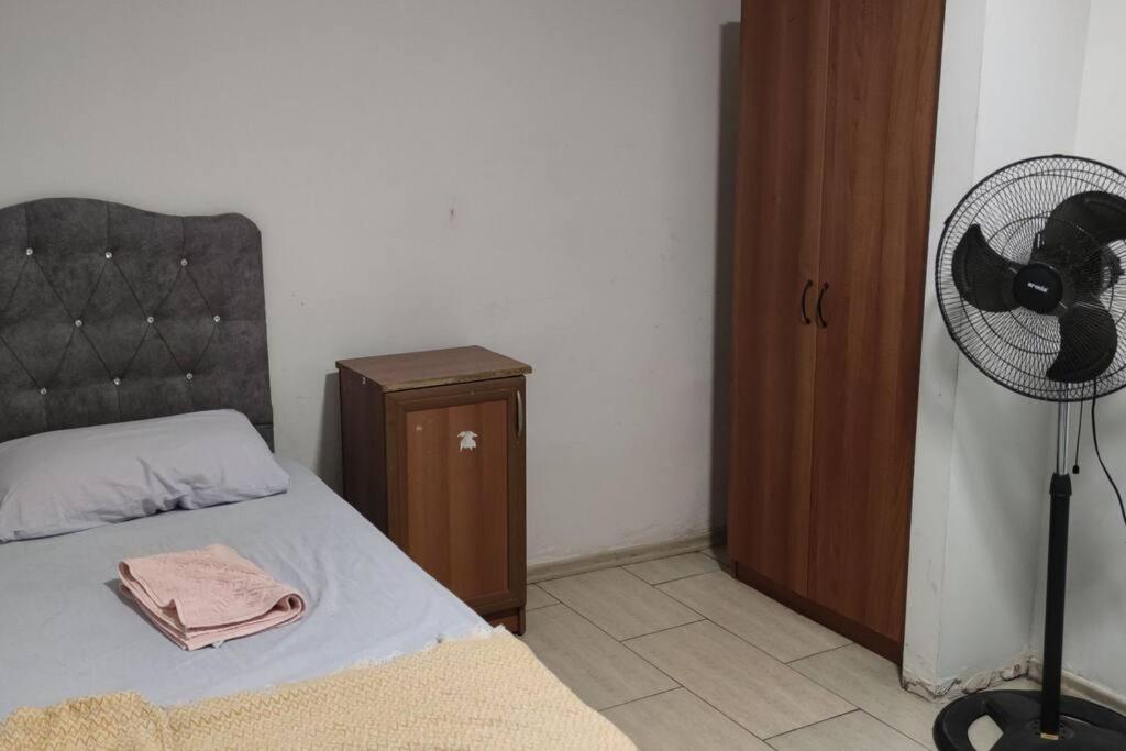 a bedroom with a bed next to a fan at Midtown Hotel Apartments 305 (0+1) in Istanbul