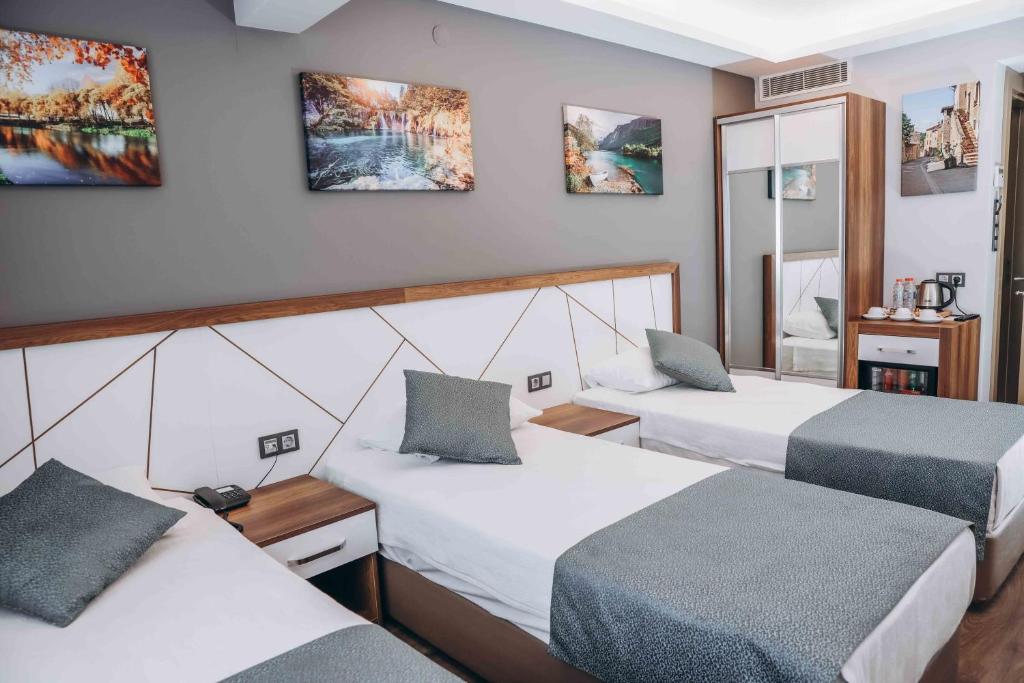 A bed or beds in a room at Hakcan Hotel