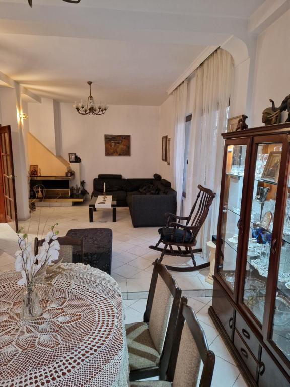 a living room with a table and a couch at Tsar Simeon, 2 bedroom, living room and fireplace in Sofia