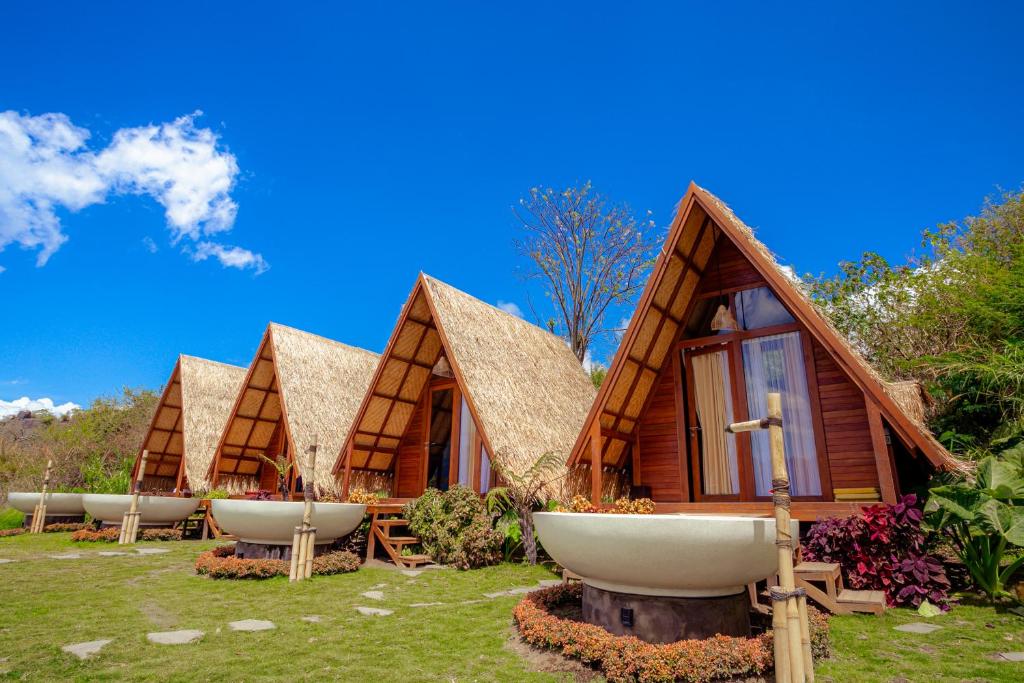 a row of cottages with large sinks in the grass at Segara Camp Kintamani in Kintamani