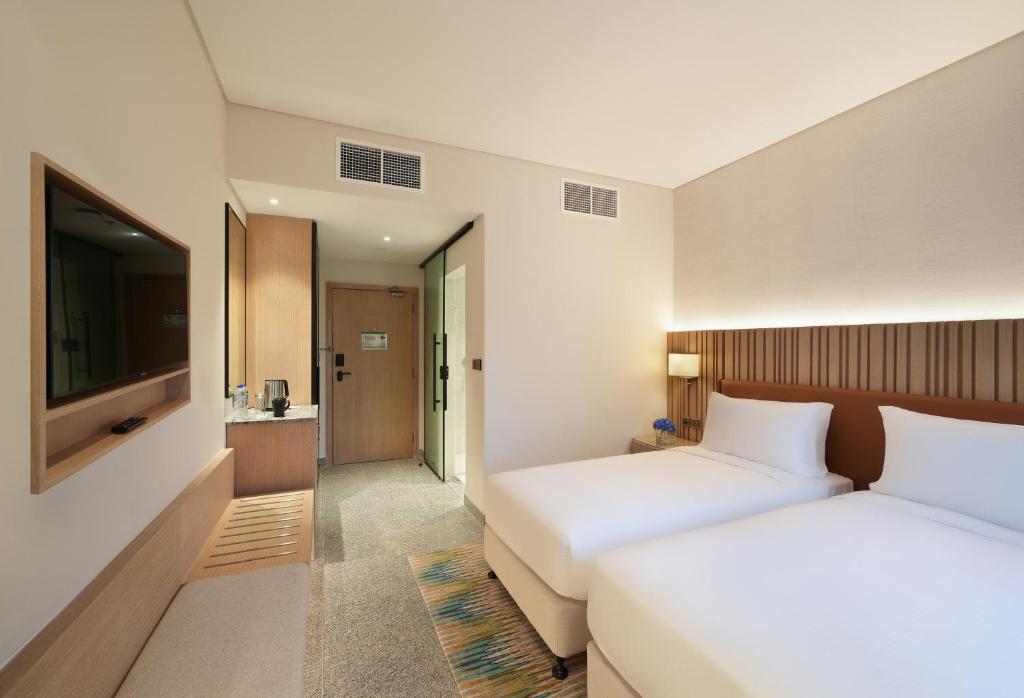 Arabian Park Dubai, an Edge by Rotana Hotelにあるベッド