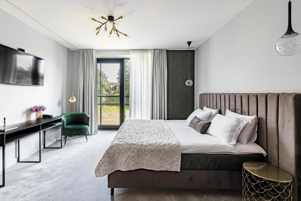 Postel nebo postele na pokoji v ubytování Oginski Hotel