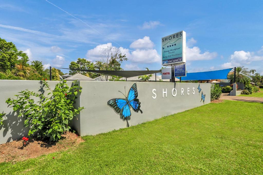 a sign for a store with a butterfly painted on it at Mission Beach Shores in Mission Beach