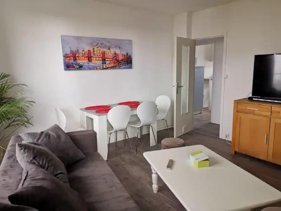 a living room with a couch and a table at apartment near the Breton coast 5 Location appartement près des côtes bretonnes in Saint-Brieuc