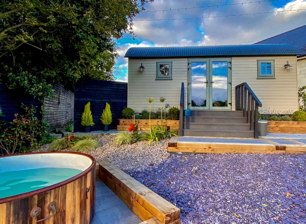 a home with a hot tub in front of a house at Bailey's Hideaway in Portadown