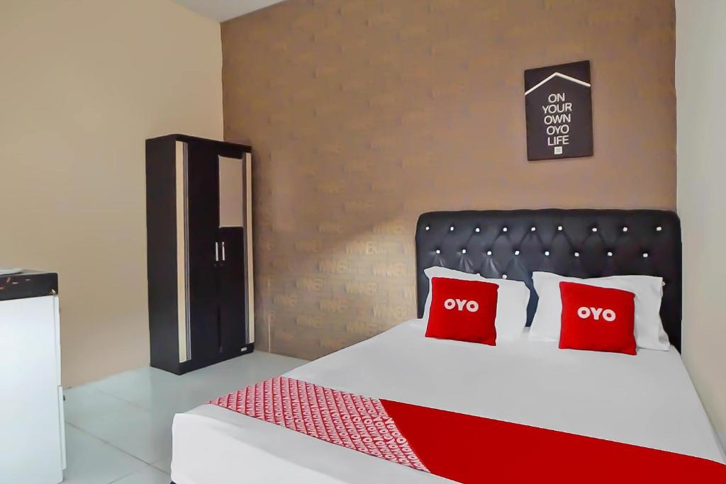 Llit o llits en una habitació de OYO 91700 N Guesthouse
