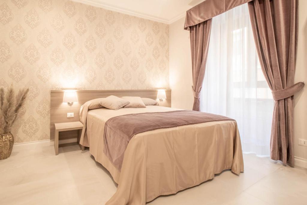 a bedroom with a large bed and a window at DANY GUEST HOUSE in Rome