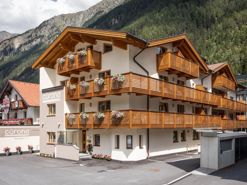 a hotel with wooden balconies on a mountain at Apart Corona in Sölden