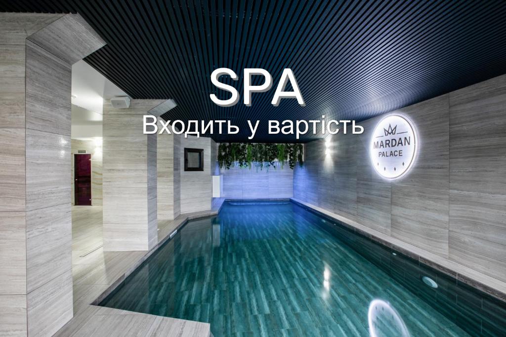 a swimming pool in a building with a spa sign at Mardan Palace SPA Resort in Bukovel