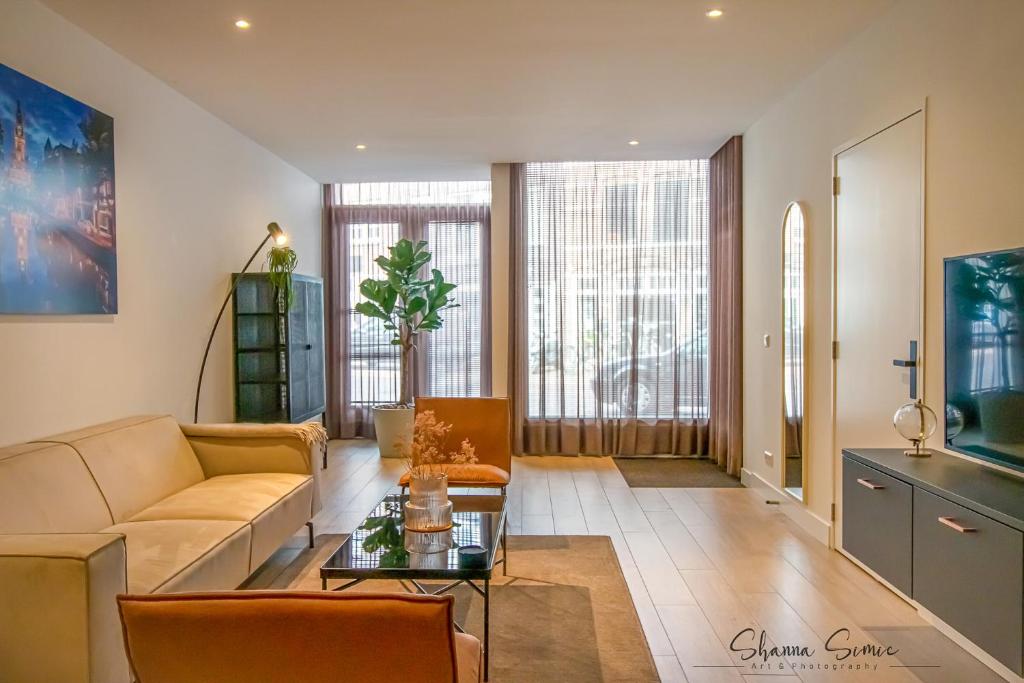 a living room with a couch and a table at ApartHotel Boutique by Urban Home Stay in Alkmaar