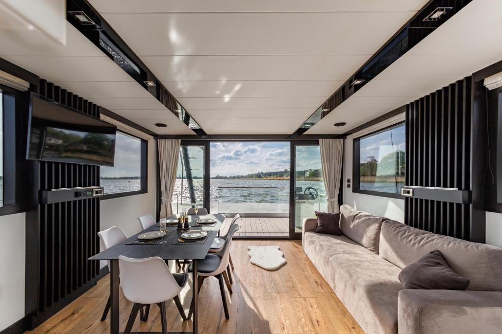 a living room with a couch and a table at Houseboat Nomadream in Gdańsk