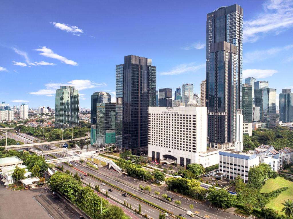 an aerial view of a city skyline with tall buildings at ARTOTEL Suites Mangkuluhur Jakarta in Jakarta