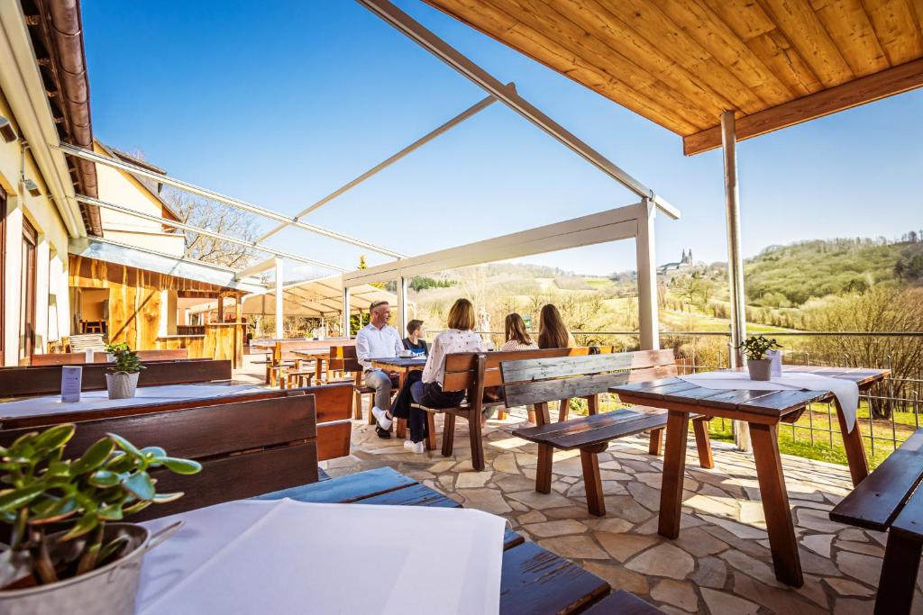 a group of people sitting at tables on a patio at Berggasthof Banzer Wald in Bad Staffelstein