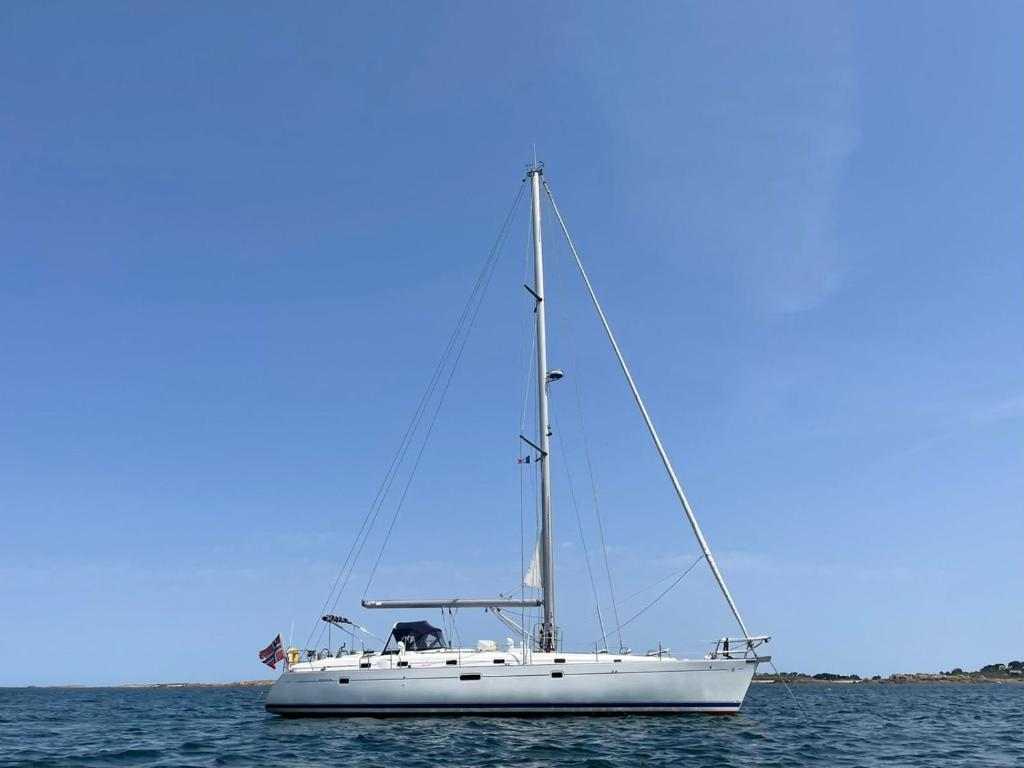 a white sailboat in the ocean on the water at Beautiful and comfortable sailboat with secure parking available in Barcelona