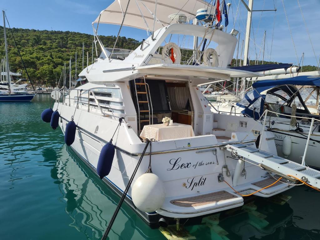 a white boat is docked in the water at Luxury Yacht - Lex of the Seas in Split