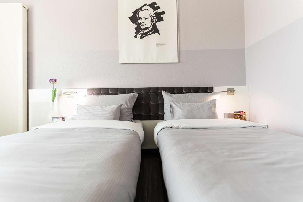 Postel nebo postele na pokoji v ubytování elaya hotel wolfenbuettel ehemals Rilano 24 7 Hotel Wolfenbüttel