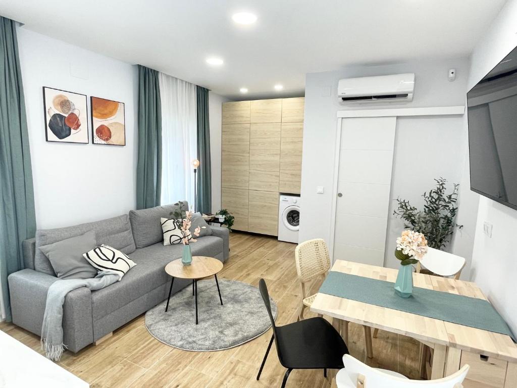 a living room with a couch and a table at Villa Verde in Madrid