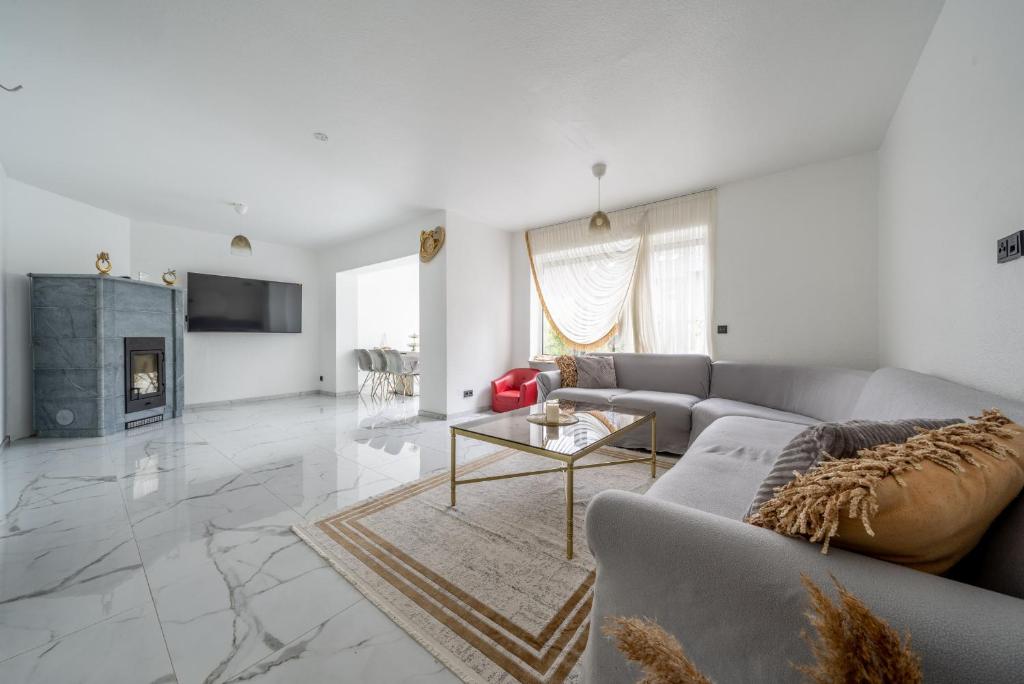 a living room with a couch and a table at Private House in Hannover