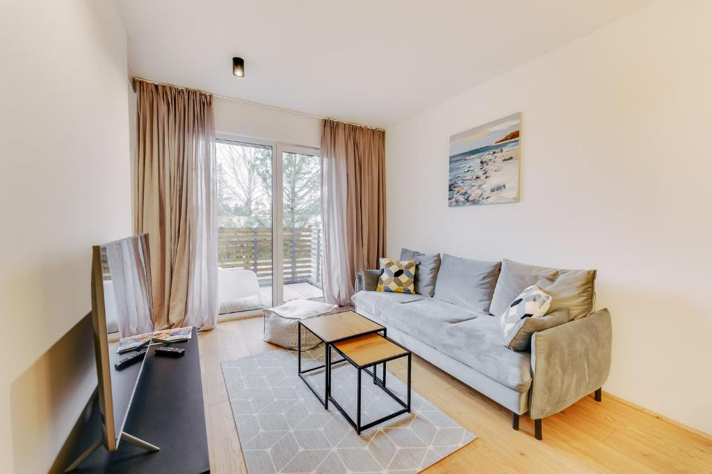 Televízia a/alebo spoločenská miestnosť v ubytovaní Apartament SAND SurfingBird Dźwirzyno