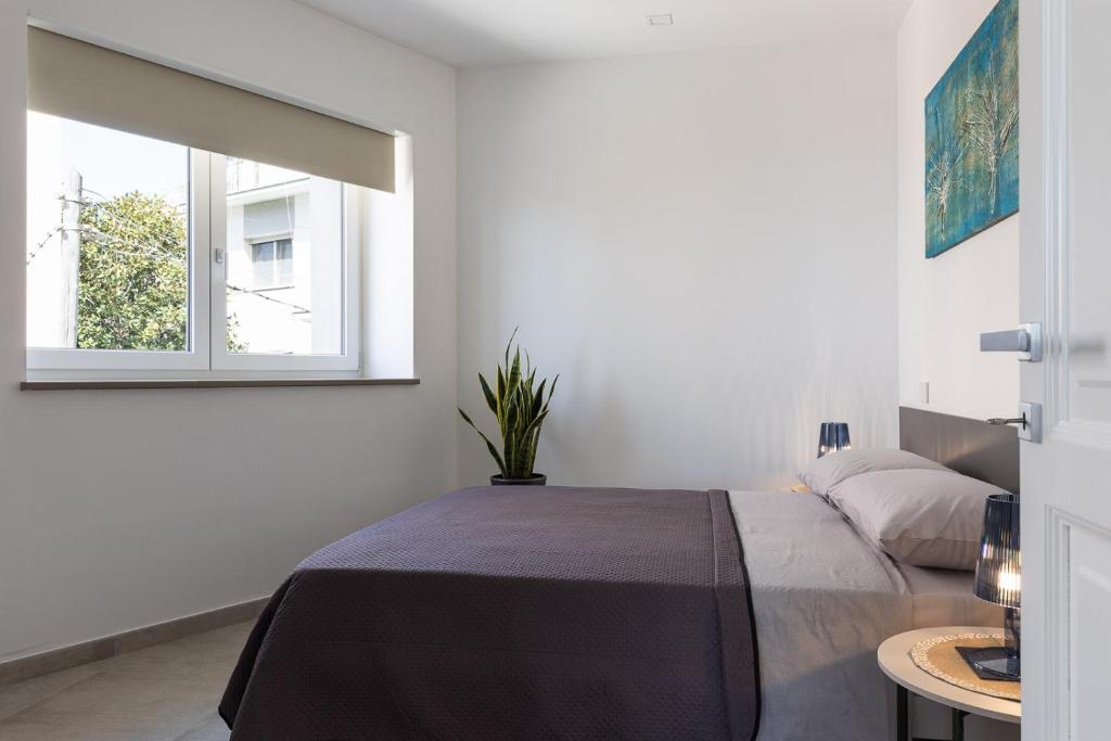 Posteľ alebo postele v izbe v ubytovaní Oneweek Gaeta Suites and Apartments