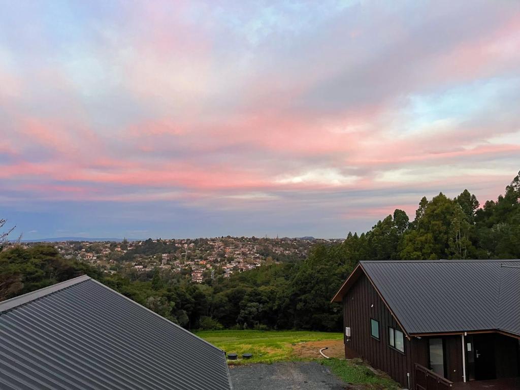a barn with a view of a city at Echo Lodge in Auckland