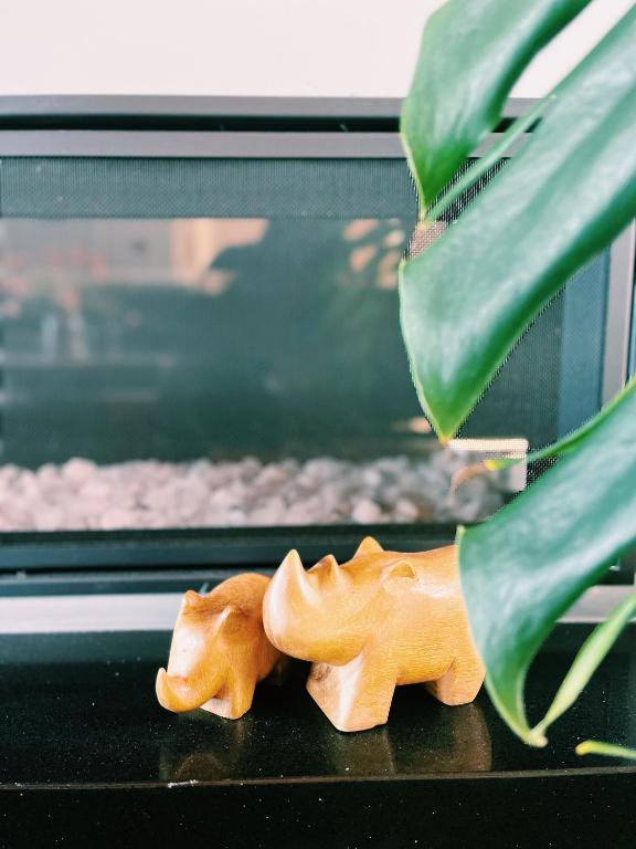 a wooden toy dog sitting next to a plant at Echo Lodge in Auckland