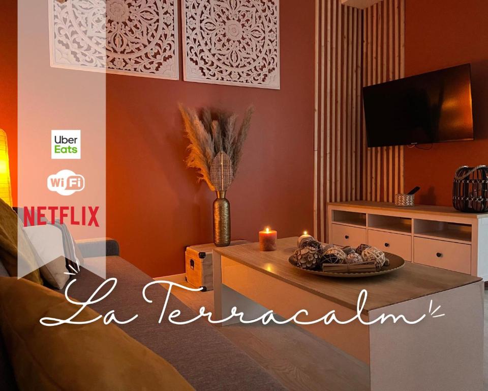 a living room with a table and a tv at - NEW - La TerraCalm - WiFi / Netflix in Cherbourg en Cotentin