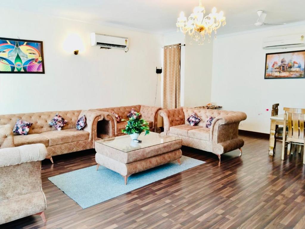 a living room with couches and a coffee table in it at Fortune Home Service Apartment 2Bhk,E28 Saket 2A in New Delhi