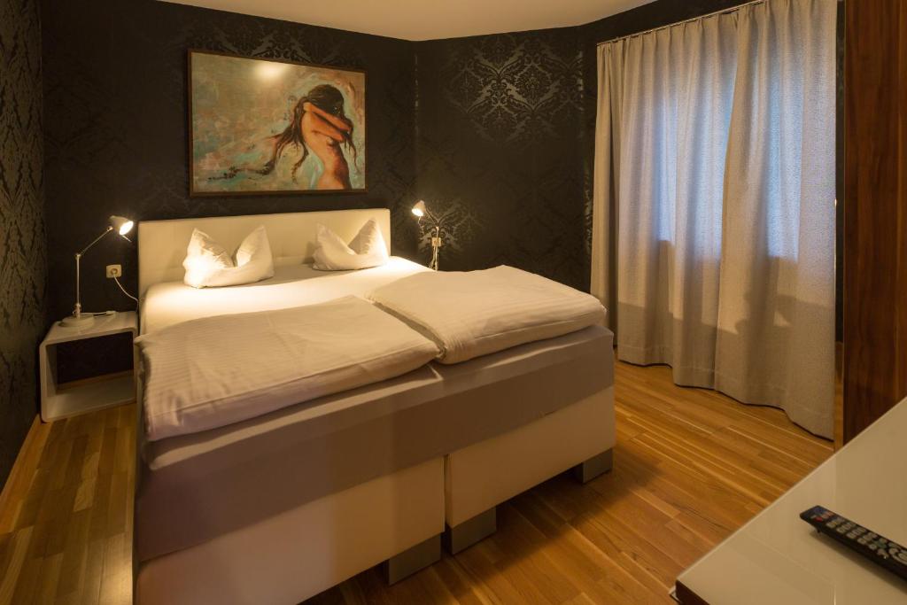 マイヤーホーフェンにあるPrachtBude Mayrhofenのベッドルーム1室(壁に絵画が描かれたベッド1台付)