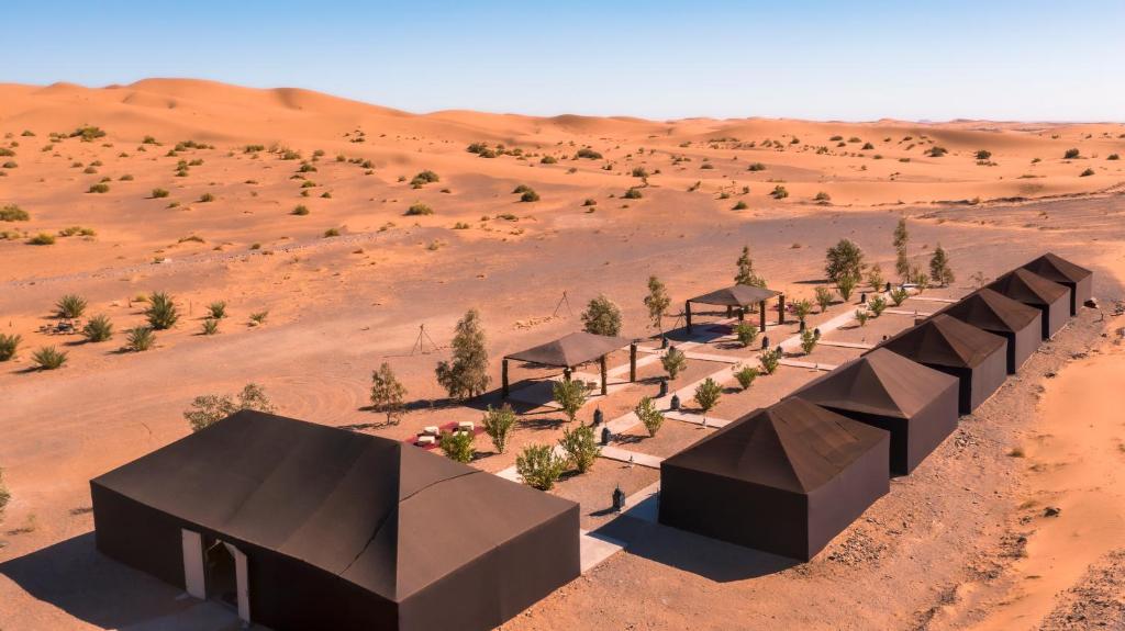 a rendering of a desertolithicolithicolithic house in the desert at Sahara Glamping in Merzouga