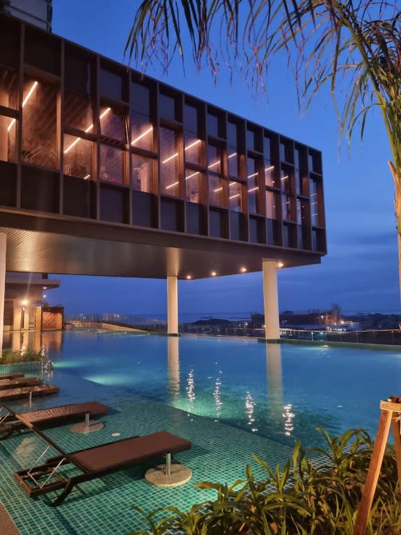 a building with a bridge over a body of water at Bali Residences Homestay Melaka Town in Malacca