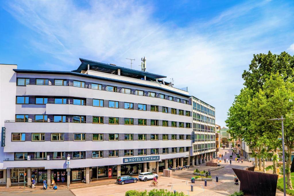 a large white building on a city street at Hotel Centrale in Mestre