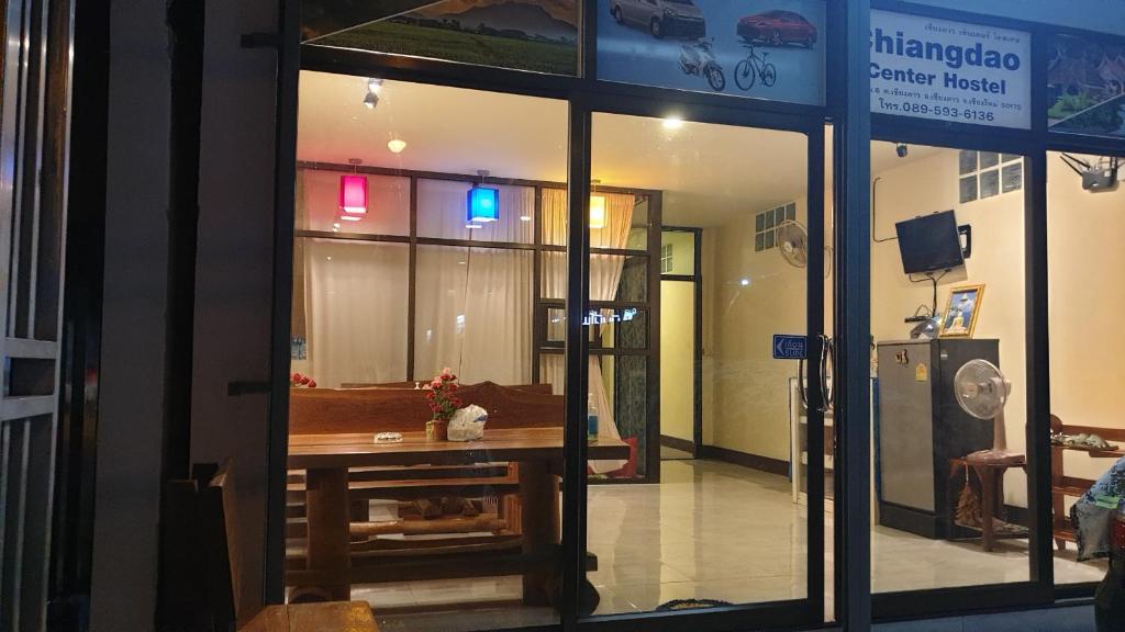 a store front with a table in a room at Chiangdao Center Hostel in Chiang Dao
