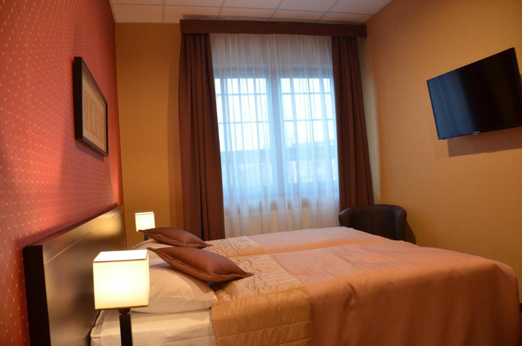 Postel nebo postele na pokoji v ubytování Hotel Pik