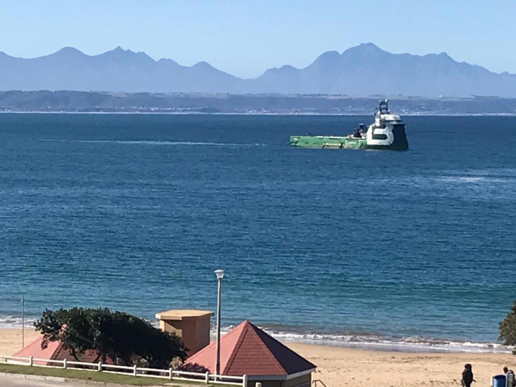 a boat floating in the water near a beach at Santos 27 Mossel Bay in Mossel Bay