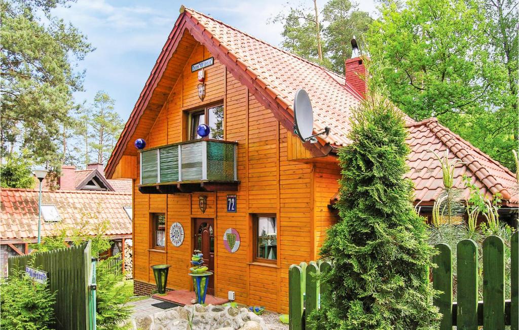 an orange house with a balcony on top of it at Beautiful Home In Grunwald With Wifi in Mielno