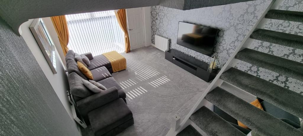 an overhead view of a living room with a couch and a television at Beautiful 2 bed house close to M74 and Strathclyde Park in Motherwell
