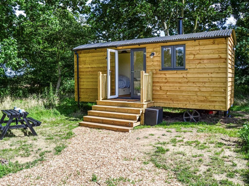 a small wooden cabin with stairs and a picnic table at Beech - Ukc4847 in Cantley