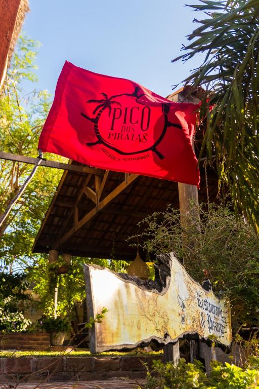 a red flag on top of a building at Pico dos Piratas in Itarema