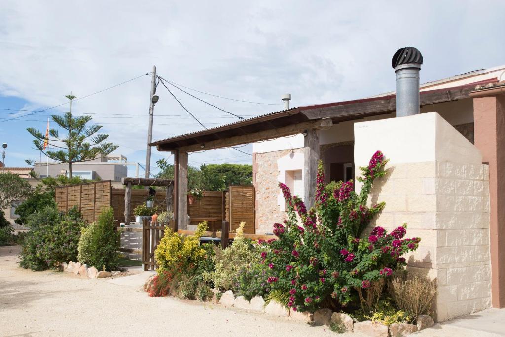 a small house with flowers in front of it at Casa Josep in Camarles