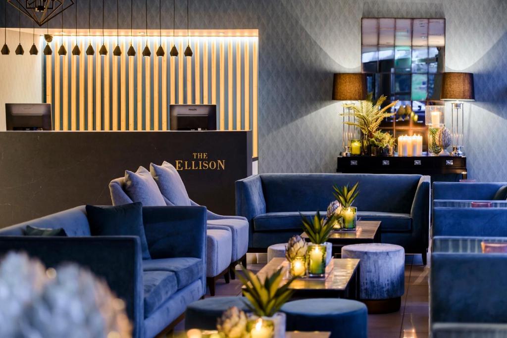 a lobby with blue couches and tables in a room at The Ellison in Castlebar
